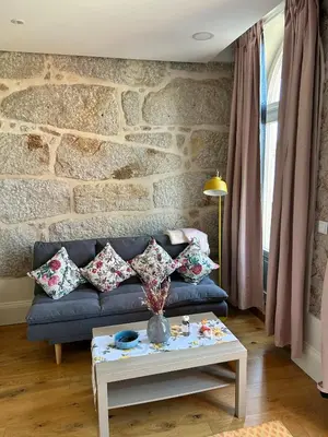 a living room with a blue couch and a table at Lazarus View Apartment in Porto