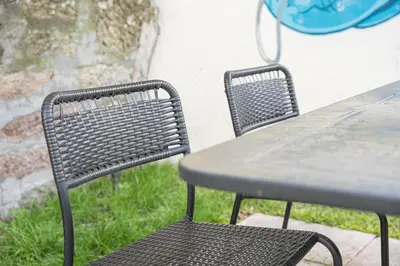 two chairs and a table and a table and a table and a table and chairs at GuestReady - One perfect home near the city centre in Porto