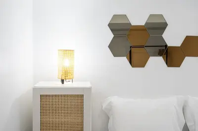 a bed with a table with a lamp on it at GuestReady - Oporto Old Town House 1 in Porto