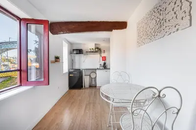 a dining room with a table and a kitchen at GuestReady - Oporto Old Town House 1 in Porto