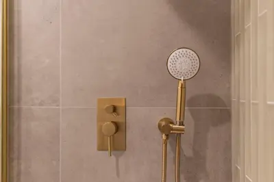 a shower with a shower head in a bathroom at DoisPontoZero Campo 24 Agosto in Porto