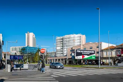 a person crossing a street in a city with a car at DoisPontoZero Campo 24 Agosto in Porto