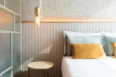 a bedroom with a large bed and a table at DoisPontoZero Campo 24 Agosto in Porto