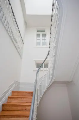 a staircase in a house with white walls and wooden floors at Liiiving in Porto - Downtown & Riverside Balcony in Porto