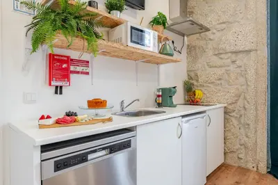 a small kitchen with a sink and a microwave at HostWise - Stylish Sunny Flats in Porto