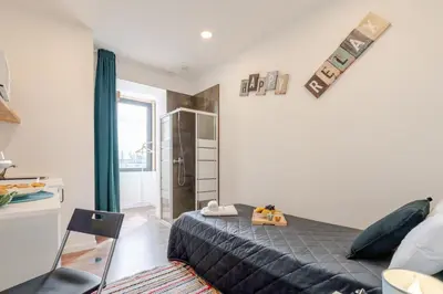 a bedroom with a large bed in a room at HostWise - Stylish Sunny Flats in Porto