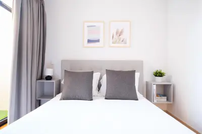 a bedroom with a white bed with gray pillows at Ekaterine Uptown in Porto