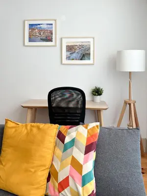 a couch with a colorful pillow in a living room at Ekaterine Uptown in Porto