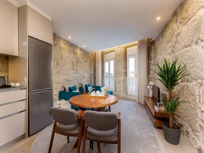 a kitchen and living room with a table and chairs at City Apartment with River Views in Vila Nova de Gaia