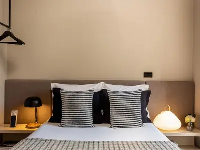 a bedroom with a bed with black and white pillows at Apartment near picturesque Ribeira do Porto in Porto