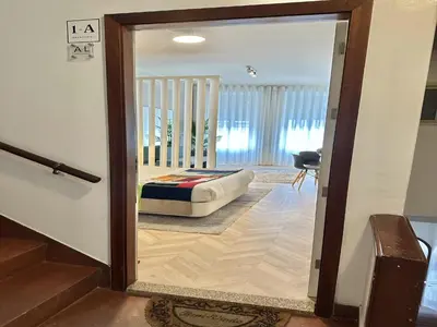 a view of a bedroom through a glass door at Centrally located apartment in Oporto in Porto