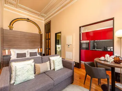 a bedroom with a couch and a table in a room at Beautiful apartment in the heart of Oporto in Porto