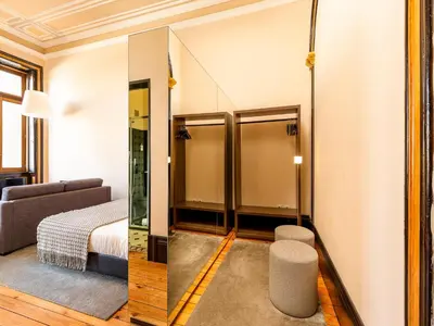 a room with a bed and a mirror at Beautiful apartment in the heart of Oporto in Porto