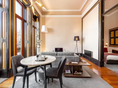 a living room with a table and a couch at Cosy apartment in heart of Porto in Porto