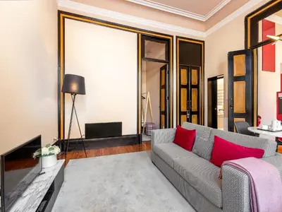 a living room with a couch and a tv at Cosy apartment in heart of Porto in Porto
