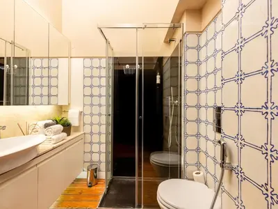 a bathroom with a toilet and a glass shower at Cosy apartment in heart of Porto in Porto