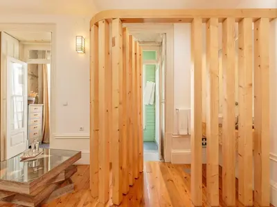 a room with wooden walls and a glass table at Modern Porto studio with essential amenities in Porto