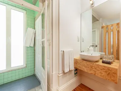 a bathroom with a sink and a mirror at Modern Porto studio with essential amenities in Porto