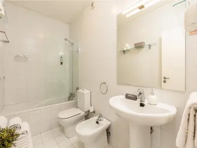 a white bathroom with a sink and a toilet at Studio with balcony in Oporto in Porto