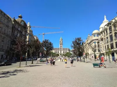 a group of people walking on a street with buildings at Cozy Urban apartment in Porto in Porto