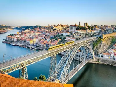 a bridge over a river with a train on it at Cozy Urban apartment in Porto in Porto