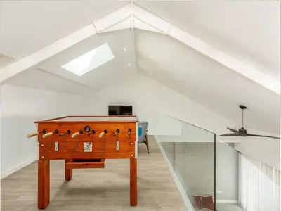 a room with a desk in a attic with a staircase at Spacious 4-Bedroom Apartment in Porto in Porto