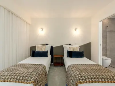 two beds sitting next to each other in a room at Spacious 4-Bedroom Apartment in Porto in Porto