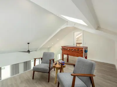 a living room with a piano and two chairs at Spacious 4-Bedroom Apartment in Porto in Porto