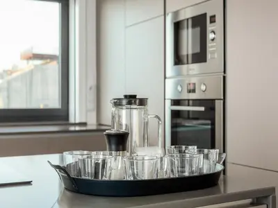 a tray filled with cups on a kitchen counter at Spacious 4-Bedroom Apartment in Porto in Porto