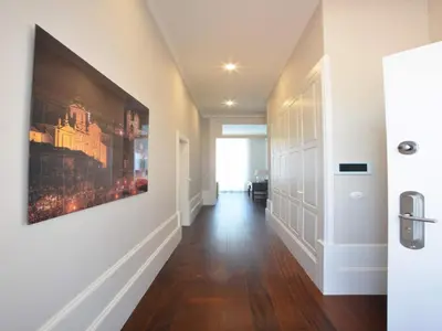 a hallway with a large painting on the wall at Spacious city apartment with modern amenities in Porto
