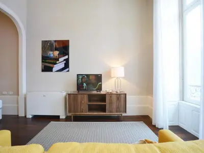 a living room with a couch and a table at Spacious city apartment with modern amenities in Porto