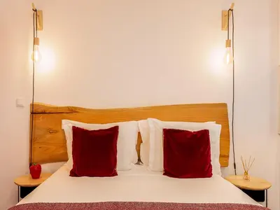 a bedroom with a bed with red pillows at Charming 1-Bedroom Apartment in Oporto in Porto