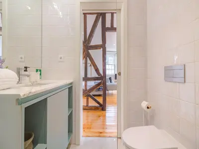 a bathroom with a sink and a toilet in it at Pretty apartment with modern comforts in Porto