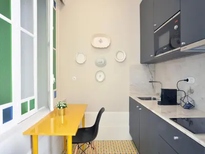 a kitchen with a yellow table and a yellow chair at Beautiful apartment in Oporto in Porto
