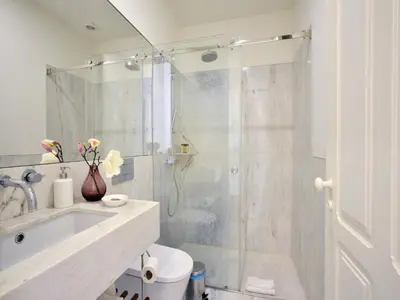a bathroom with a shower and a toilet and a sink at Beautiful apartment in Oporto in Porto