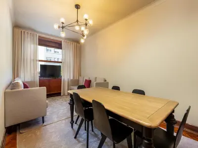 a dining room with a wooden table and chairs at Spacious 4-Bedroom Apartment in Porto in Porto