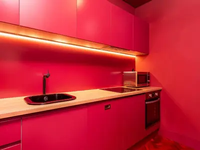 a red kitchen with a sink and a microwave at Spacious 4-Bedroom Apartment in Porto in Porto