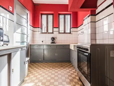 a kitchen with red and white walls and a sink at Spacious 4-Bedroom Apartment in Porto in Porto