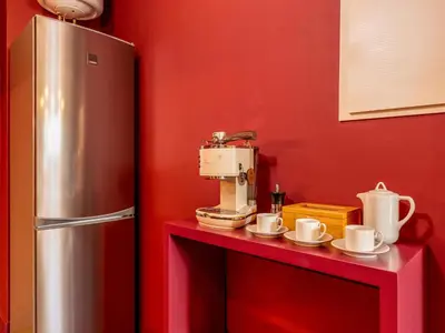 a kitchen with a coffee maker on a red counter at Spacious 4-Bedroom Apartment in Porto in Porto