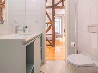 a white bathroom with a sink and a toilet at Charming studio in the heart of Porto in Porto