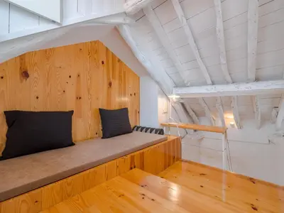 a bed in a room with a wooden wall at Central Porto with comfort & convenience in Porto