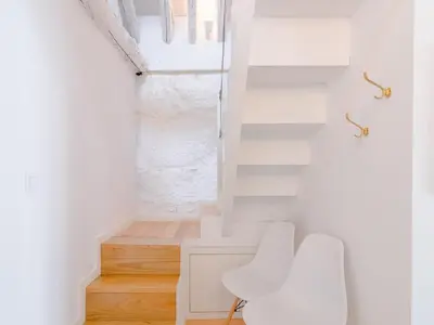 a white room with two white chairs and a window at Central Porto with comfort & convenience in Porto