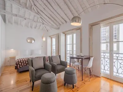 a bedroom with a bed and a table and chairs at Central Porto with comfort & convenience in Porto