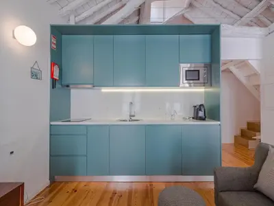 a kitchen with blue cabinets and a sink at Central Porto with comfort & convenience in Porto