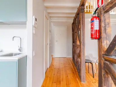 a fire extinguisher hanging on a wall in a kitchen at Comfortable apartment in Oporto in Porto