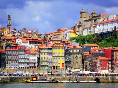 a group of colorful buildings on the side of a river at Stylish Porto escape with essential comforts in Porto