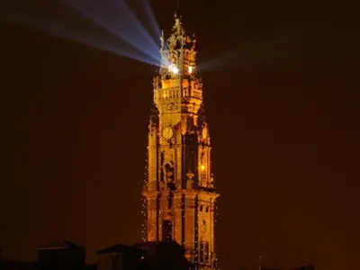 a tall clock tower with a light on top at night at Stylish Porto escape with essential comforts in Porto