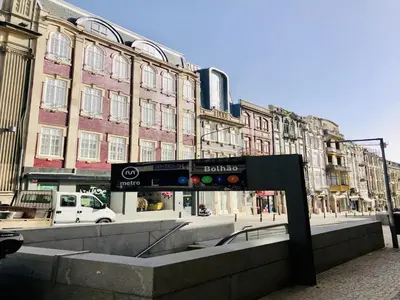a sign in the middle of a street with buildings at Convenient apartment in the heart of Porto in Porto