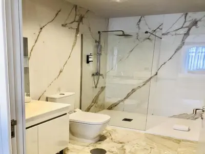 a bathroom with a toilet and a glass shower at Convenient apartment in the heart of Porto in Porto