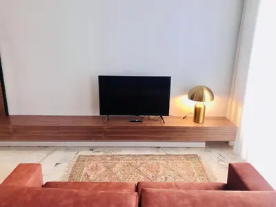 a living room with a couch and a flat screen tv at Convenient apartment in the heart of Porto in Porto
